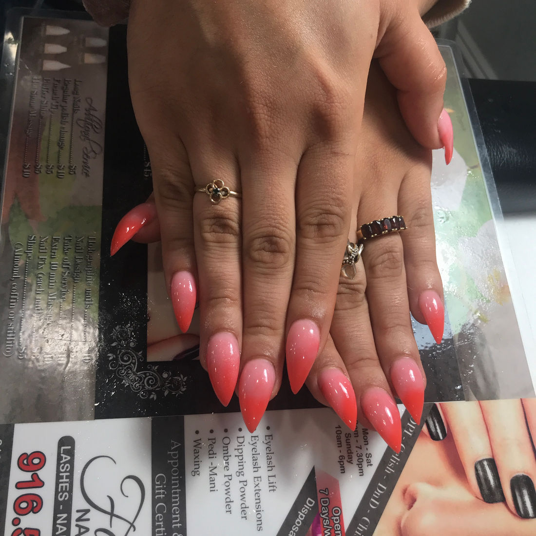 Coral almond-shaped gel nails done at Fabulash