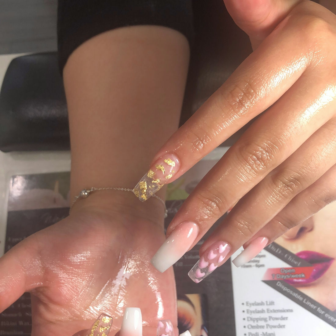 Long nude nails with glitter accent